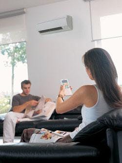 Couple comfortably sitting in an air-conditioned living room